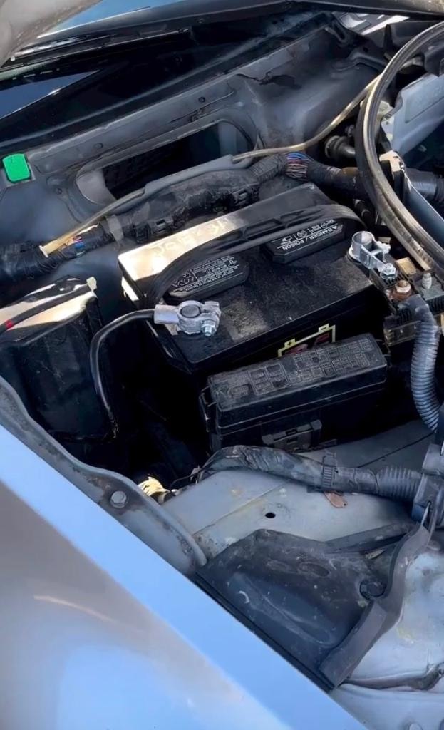 Engine bay detail showing battery and fuse box on a past project build